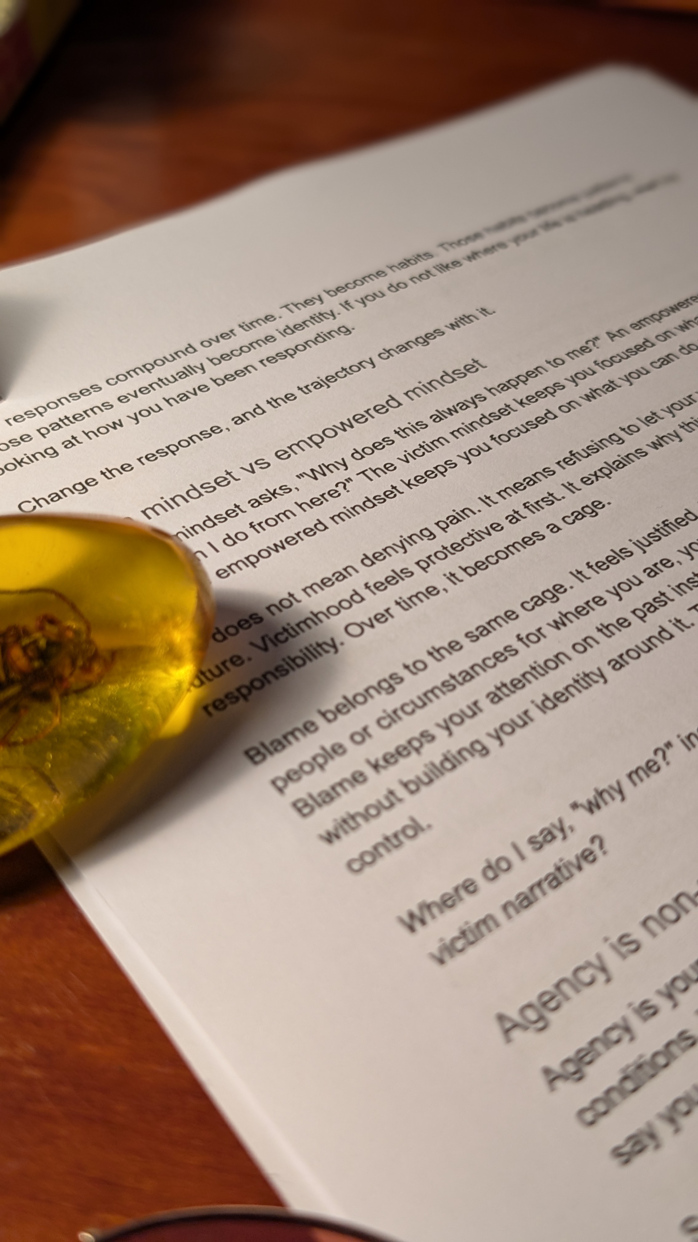 Printed manuscript page with underlined passages and margin notes, photographed on a desk.