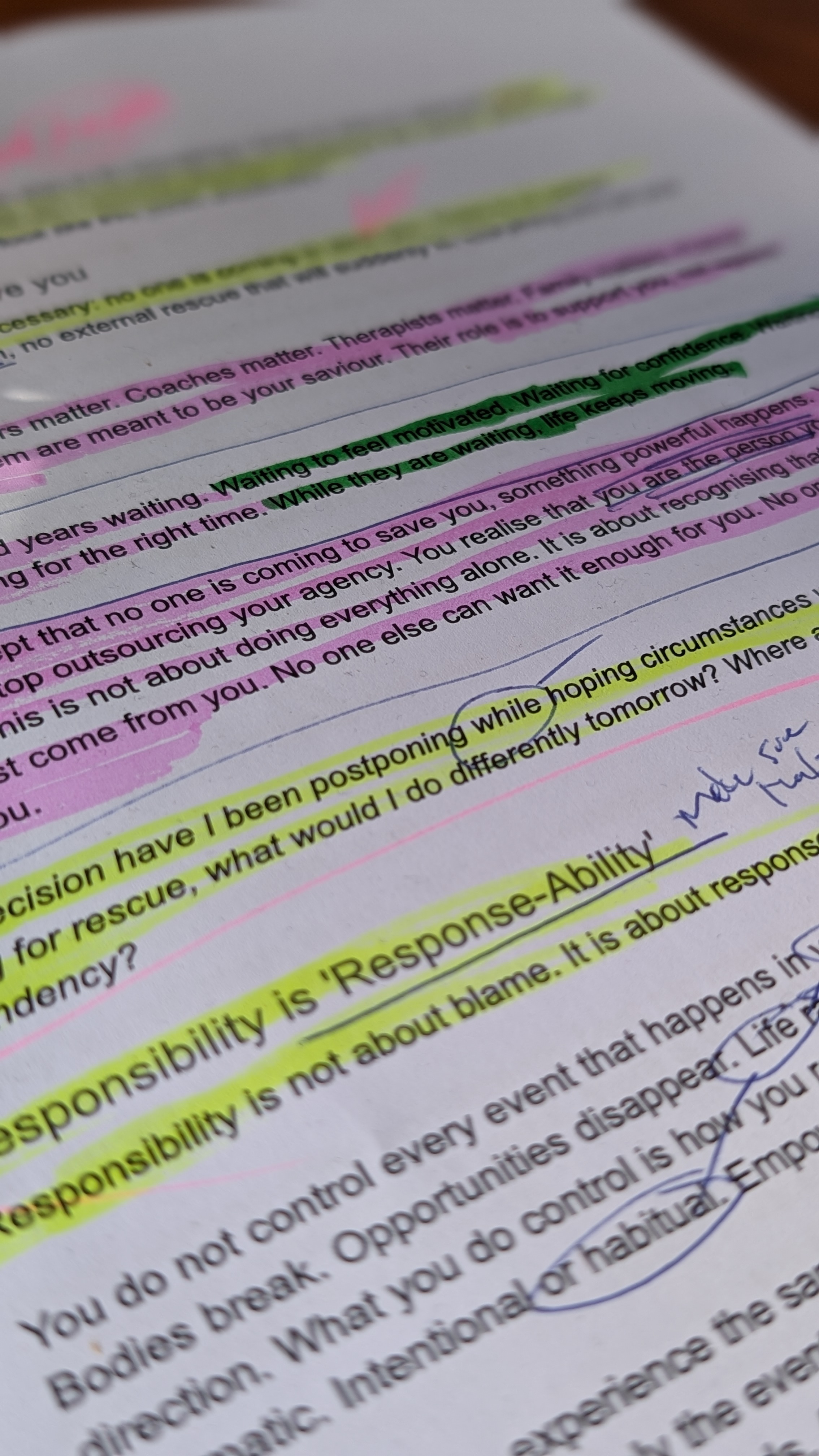 Printed manuscript page marked up with pink, green, and yellow highlighter and handwritten annotations in the margin.